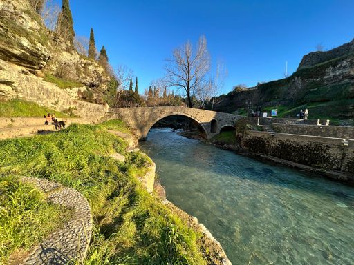 A historic old bridge over a flowing river in Podgorica, Montenegro