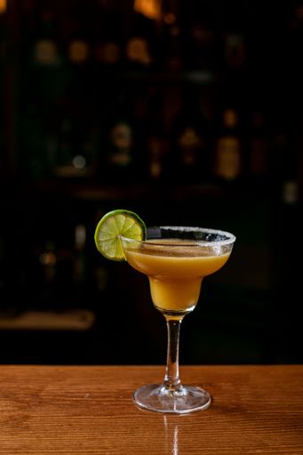 Tasty daiquiri cocktail with lime served on a bar counter