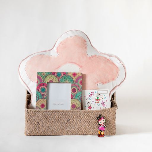 A gift set of a pillow with cute drawings on it and picture frames in a box