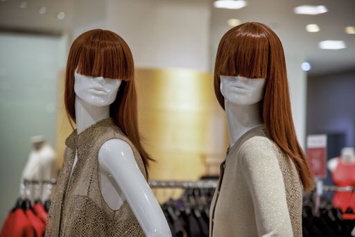 Two white mannequins with red haired wigs in a shop captured in San Francisco, United States