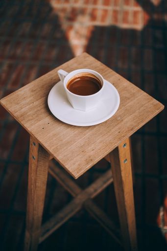 a coffee mug, with a cup of espresso on the wooden table wallpaper