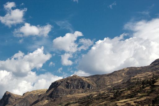The mountains gleaming under the fluffy cloudy sky