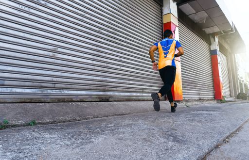 A young Hispanic male jogging outside