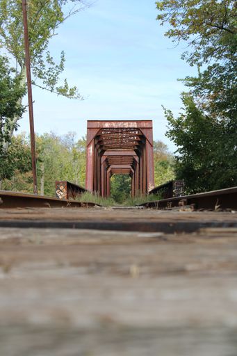 A beautiful view of an iron bridge from the railway track during sunrise