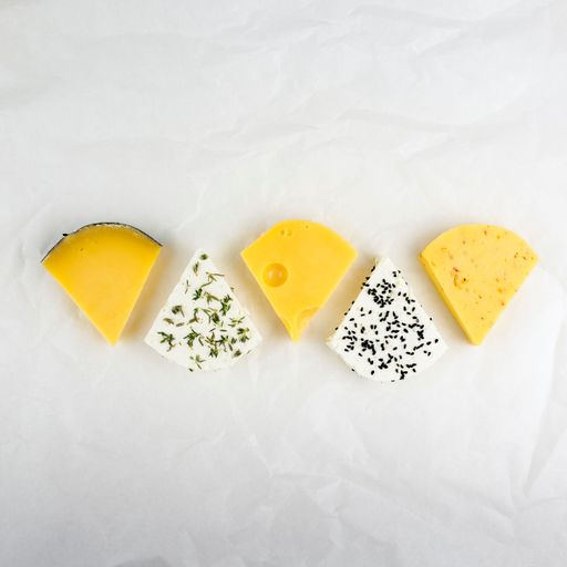 A closeup of different type of cheese in white background