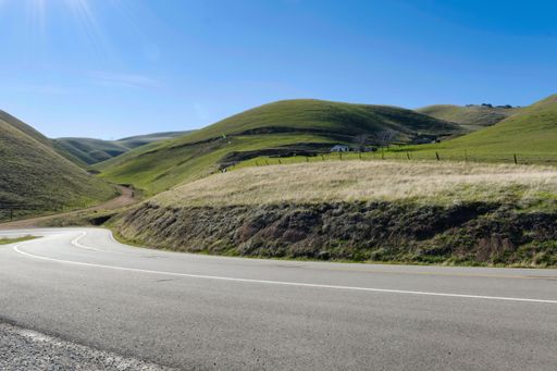 A scenic view of a Winding road going through a landscape in the countryside