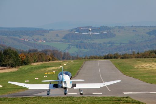 A small aircraft with mountains on the background