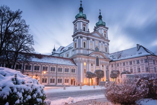 A view of basilica cathederal building facade in snowy evening in Waldsassen