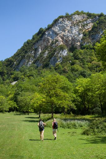 A vertical shot of two woman hikers hiking in the green nature of Cerdon, Ain, in Eastern France
