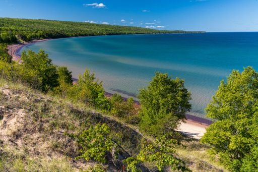 A high angle of Great Sand Bay of Lake Superior covered with greenery on Keweenaw peninsula, Michigan