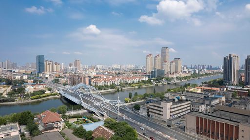 Aerial view of a the Zhigu Bridge over Haihe River with urban buildings and landmarks in Tianjin, China