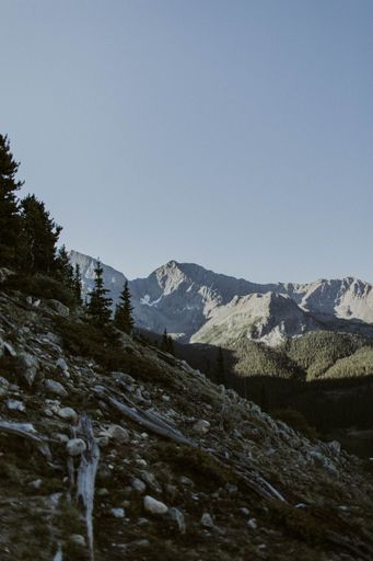 A vertical shot of the rocky slope with mountains in the background.