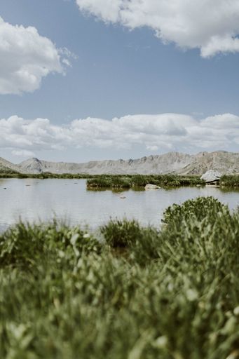 A vertical shot of the lake and mountains against the background of blue sky.