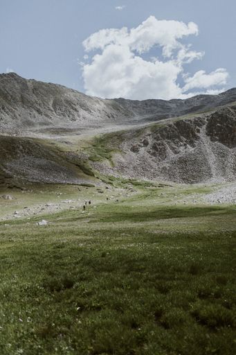 A vertical shot of the green vale and mountains.