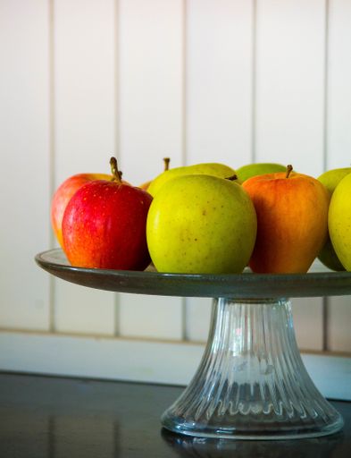 A vertical shot of apples on the vase