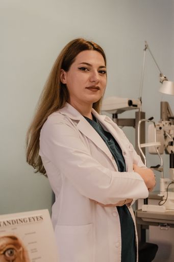 A vertical portrait of an ophthalmologist in her consultation room