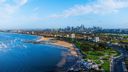 An aerial shot of the coastal Melbourne city in Australia with buildings in on the shore