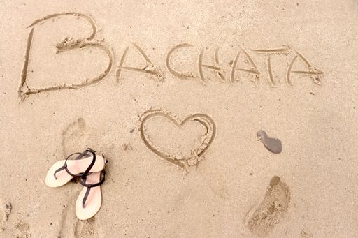 A writing "Bachata" on the sand in a beach