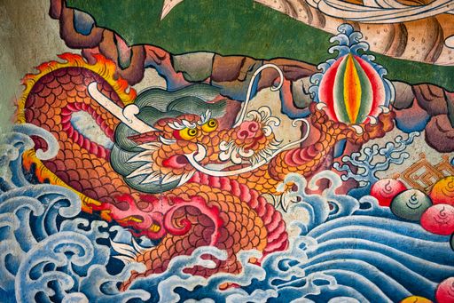 A closeup shot of a Buddhist painting with mural dragons
