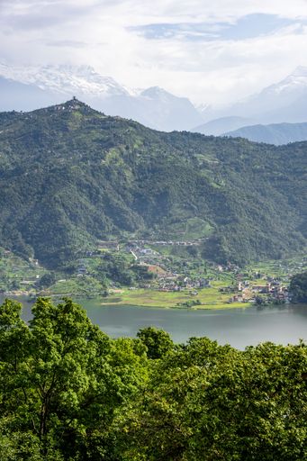 A vertical shot of Pokhara city with lake Phewa and Annapurna Himalayan mountain range in Nepal.