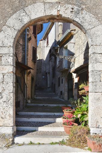 A narrow street between the old stone houses of Collepardo, a medieval village in the Lazio region.