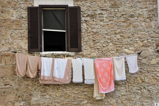 Typical scene in a small town in Italy with clothing hanging by the windo