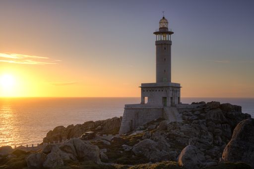 A closeup of the Punta Nariga Lighthouse in Galicia at sunset