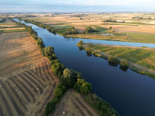 A high-angle shot of Odra river near Opole under the cloudy sky.