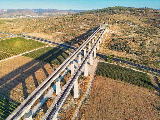 Aerial view of a two way trains bridges with a tunnel at a distance