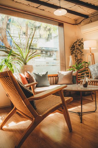 A vertical shot of the rustic interior of a beautiful cafe with tables and seats