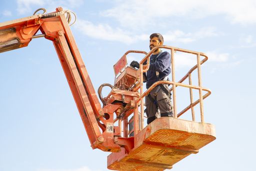 A low angle shot of a man working at a construction site - concept of construction