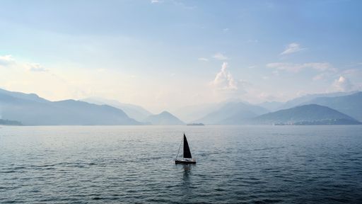 A beautfiful view of a boat sailing on the lake Maggiore, Italy