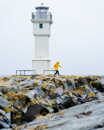 A vertical shot of a white lighthouse in Akranes, Iceland