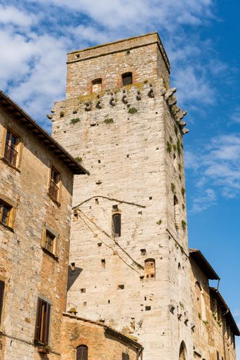 A vertical shot of the tower of a historic building in San Gimignano, Italy