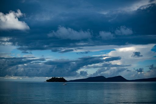 A tiny tropical Island under a clear sky