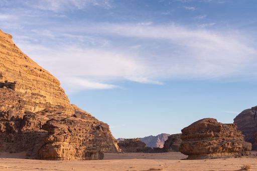A scenic view of the Wadi Rum desert with huge canyons under the blue sky