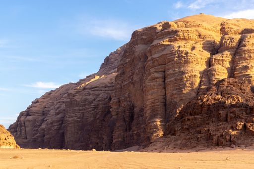 A scenic view of the Wadi Rum desert with huge canyons under the blue sky