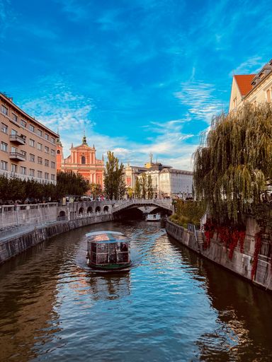 A breathtaking cityscape view of the Slovenian capital Ljubljana over Ljubljanica river under blue sky
