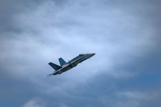 The Royal Canadian Air Force CF-18 Hornet banked turn over on blue cloudy sky Springbank Airport, Alberta