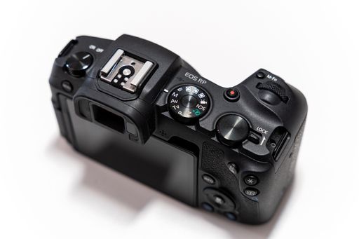 A top view of a Canon EOS RP camera on a white background
