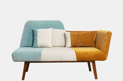 A studio shot of a modern sofa in a white background