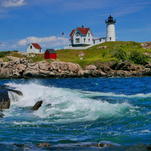 The view of Nubble lighthouse on the coast under the blue sky