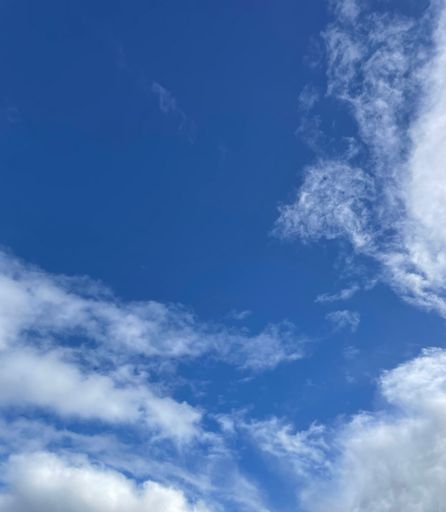 The white fluffy cloudscape in the blue sky resembling an envelope