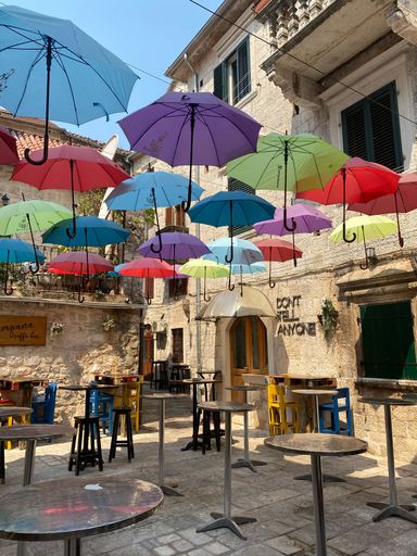 The outdoor Karampana Caffe Bar with colorful umbrellas hanging in the air