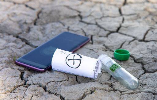 A closeup of geocache log roll and smartphone