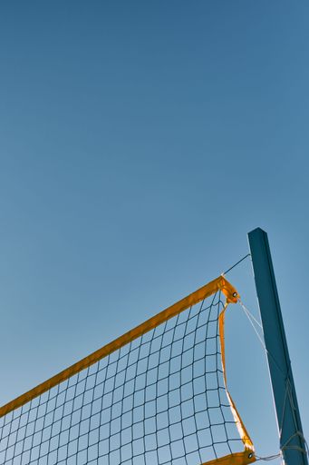 A beautiful view of a volleyball net with blue sky background