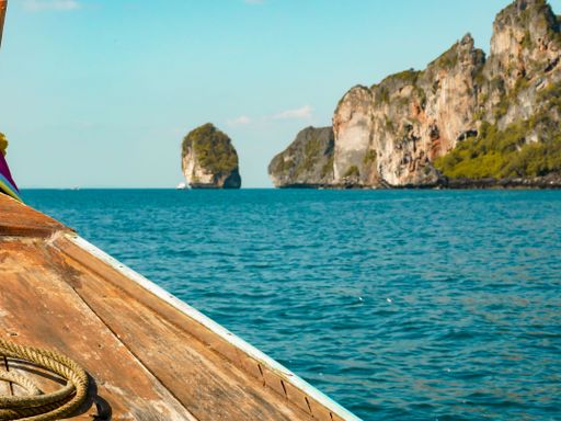 A ship with a sea and koh phi phi land in the background, thailand