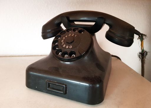 A high angle shot of a black old telephone on a table