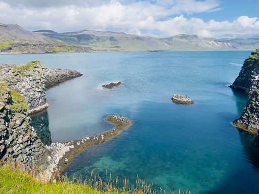 Beautiful view of volcanic rock formation, blue and turquoise water, sunny summer day Snaefellsnes peninsula in Iceland