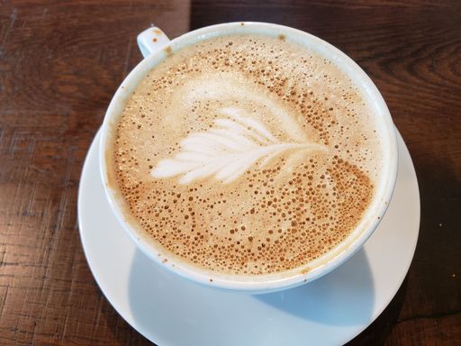 A cup of hot, delicious cappuccino on the table, close-up